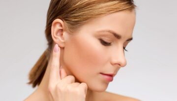 calm woman touching her ear